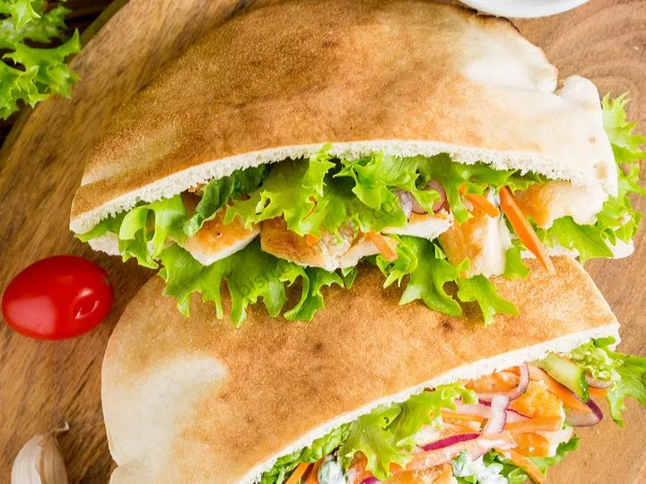 Warm stuffed pita bread filled with fresh vegetables and meat, smooth dough sheeted evenly